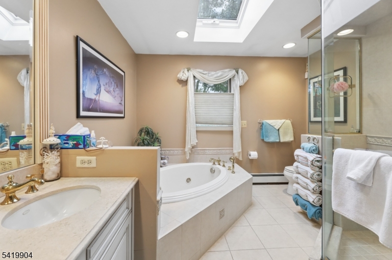 7 Valen Court Franklin Lakes, NJ 07417 - Photo 23 of 32 a bathroom with a tub sink and mirror