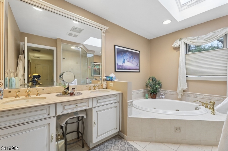 7 Valen Court Franklin Lakes, NJ 07417 - Photo 24 of 32 a spacious bathroom with a tub double sink and mirror