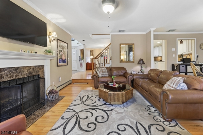 7 Valen Court Franklin Lakes, NJ 07417 - Photo 5 of 32 a living room with furniture a flat screen tv and a fireplace