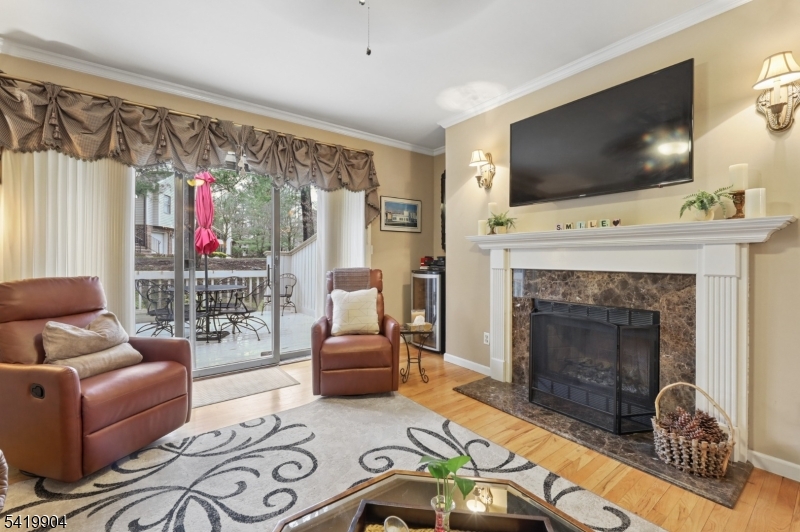 7 Valen Court Franklin Lakes, NJ 07417 - Photo 6 of 32 a living room with furniture a flat screen tv and a fireplace