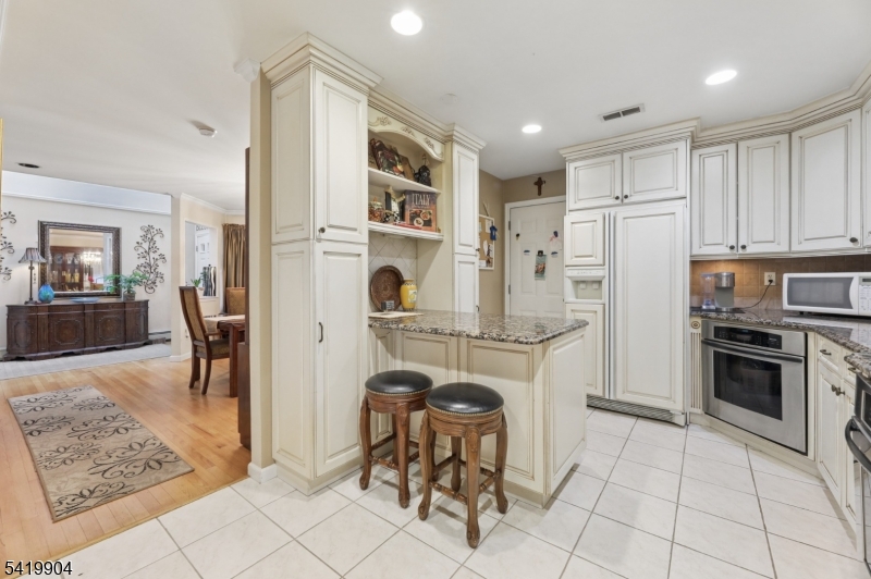 7 Valen Court Franklin Lakes, NJ 07417 - Photo 10 of 32 a kitchen with stainless steel appliances granite countertop a refrigerator and a stove top oven