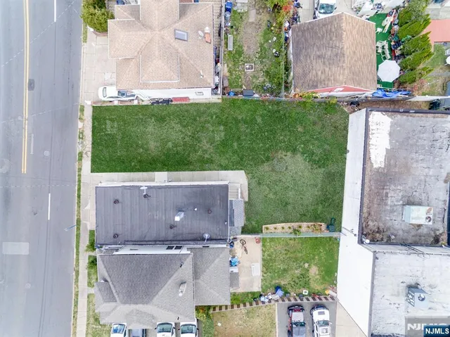 an aerial view of a house with a garden and a yard