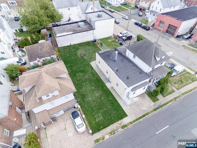 an aerial view of residential house with outdoor space and street view