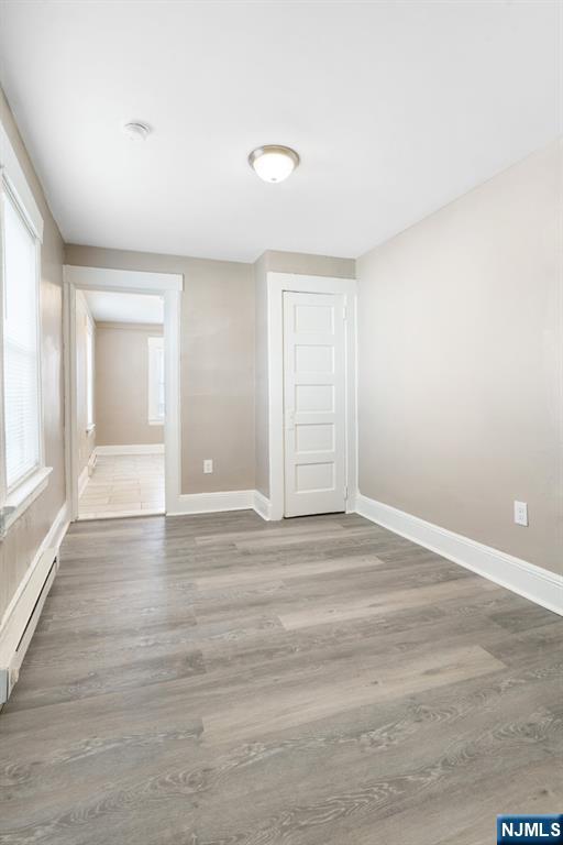 52 South State Street Hackensack, NJ 07601 - Photo 3 of 14 an empty room with wooden floor and windows