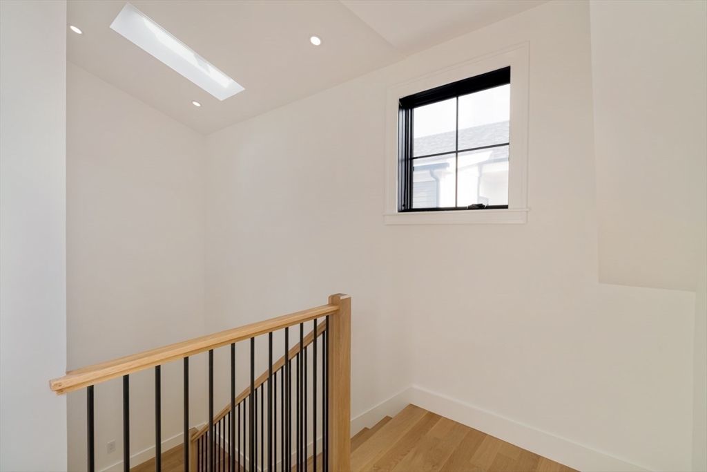 17 South Waverly Street, Unit 17 Boston, MA 02135 - Photo 19 of 29 wooden floor in an empty room with a window