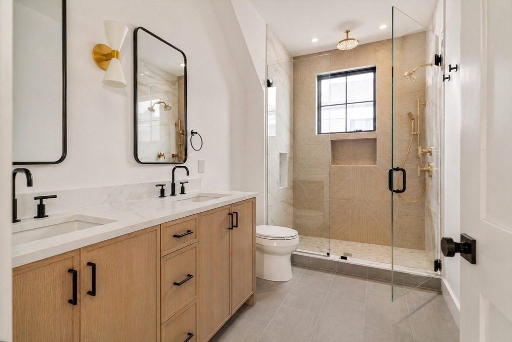 17 South Waverly Street, Unit 17 Boston, MA 02135 - Photo 21 of 29 a bathroom with a double vanity sink toilet and shower