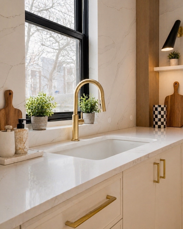 17 South Waverly Street, Unit 17 Boston, MA 02135 - Photo 6 of 29 a vase of flowers sitting on a sink