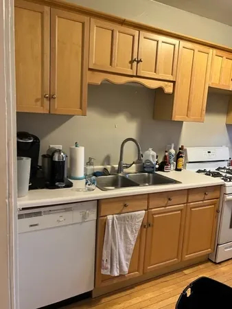 a kitchen with stainless steel appliances granite countertop a sink a stove and cabinets
