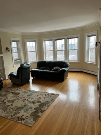 a living room with furniture window and wooden floor