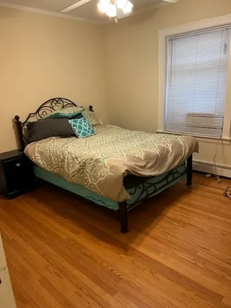 a bedroom with a bed and window