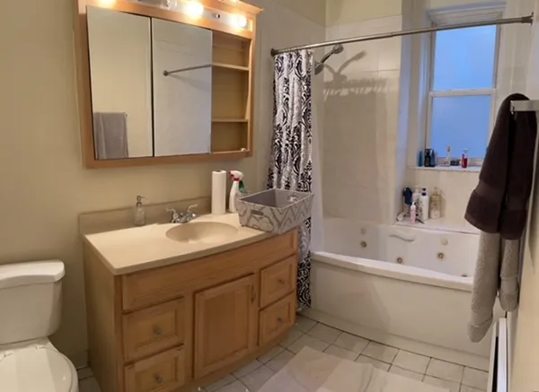 a bathroom with a sink toilet and shower