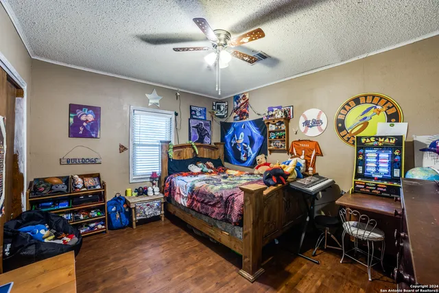 a bedroom with bed and a chandelier