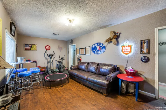 a living room with furniture a rug and a table