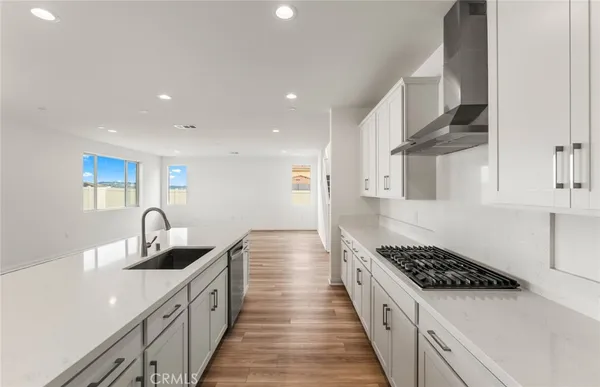 a kitchen with stainless steel appliances a sink stove and cabinets