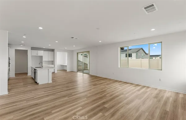 a view of kitchen with furniture and wooden floor