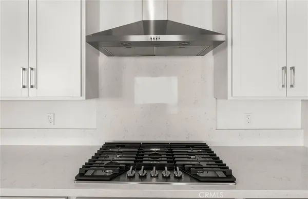 a kitchen with granite countertop a stove and a cabinet