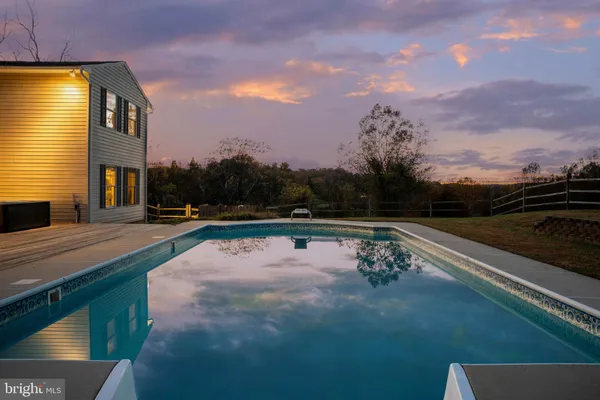 a view of outdoor space with swimming pool and furniture