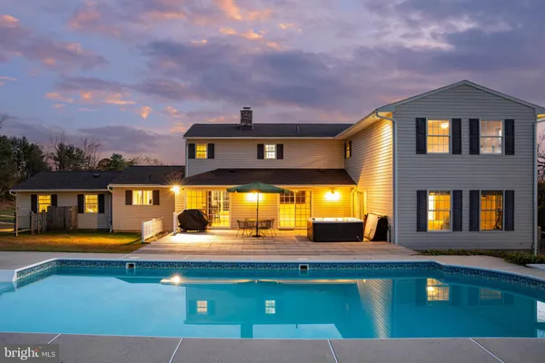 a view of a house with a backyard patio and fire pit