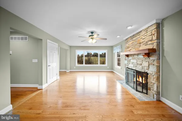 a view of an empty room with a fireplace and a flat screen tv