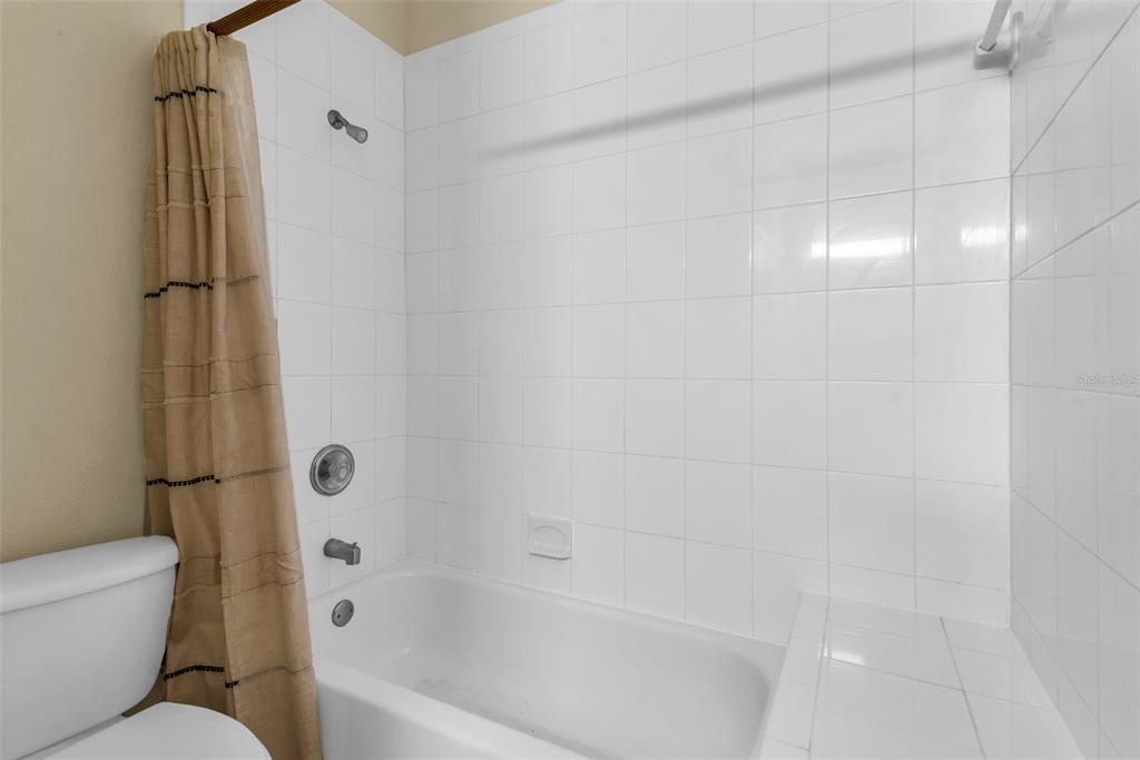1425 Riviera Drive Kissimmee, FL 34744 - Photo 35 of 82 a bathroom with a bathtub and toilet