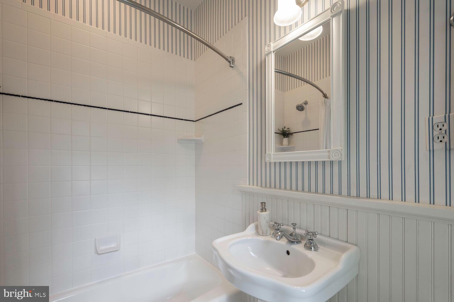 5804 Cedar Parkway Chevy Chase, MD 20815 - Photo 32 of 95 a bathroom with a sink and a mirror