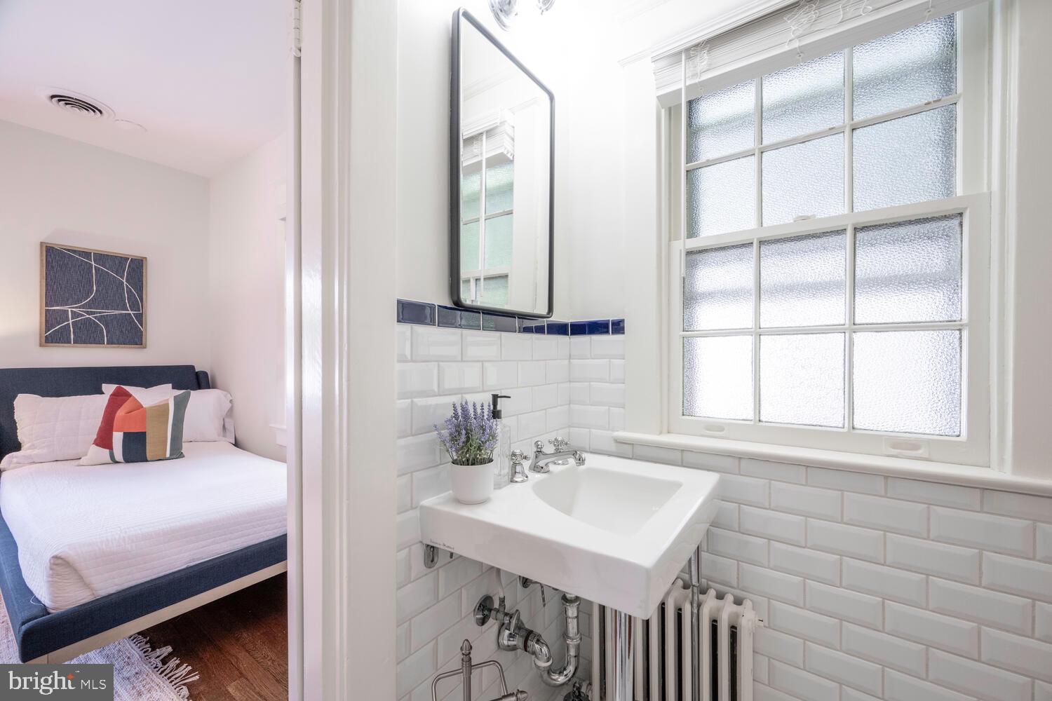 5804 Cedar Parkway Chevy Chase, MD 20815 - Photo 51 of 95 a bathroom with a sink and a mirror