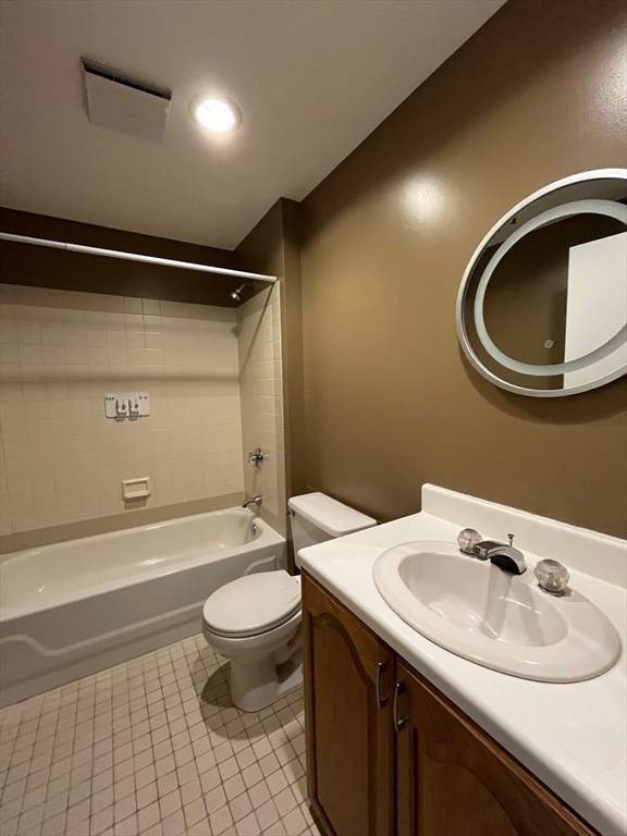 750 Davol Street, Unit 119 Fall River, MA 02720 - Photo 11 of 12 a bathroom with a sink a toilet and a mirror