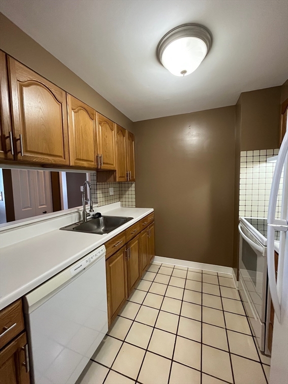750 Davol Street, Unit 119 Fall River, MA 02720 - Photo 9 of 12 a kitchen with a sink cabinets and appliances