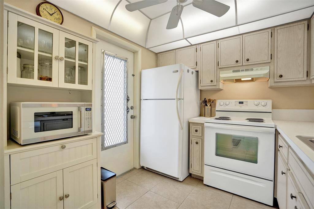 4431 Northwest 16th Street, Unit 209 Lauderhill, FL 33313 - Photo 12 of 27 a white refrigerator freezer and a stove sitting inside of a kitchen