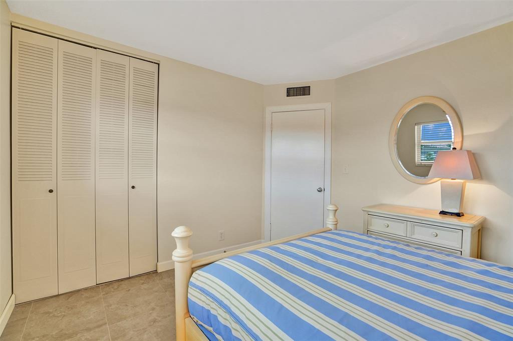 4431 Northwest 16th Street, Unit 209 Lauderhill, FL 33313 - Photo 20 of 27 a bedroom with a bed and a chandelier
