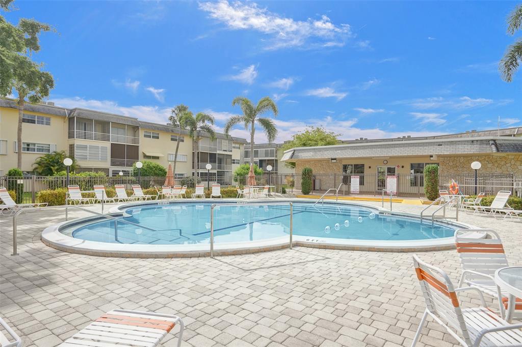 4431 Northwest 16th Street, Unit 209 Lauderhill, FL 33313 - Photo 26 of 27 a view of houses with a swimming pool
