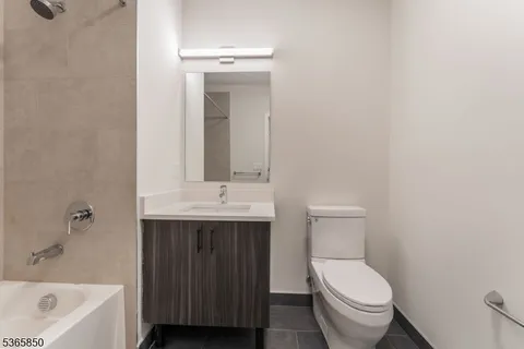 a bathroom with a sink a toilet and bathtub
