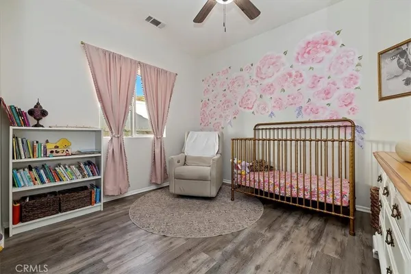 a bedroom with furniture and a book shelf