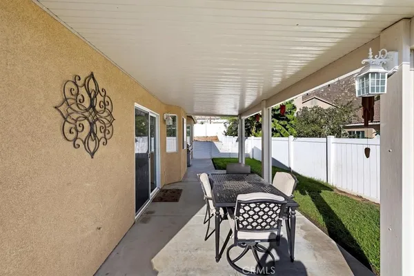 a view of a patio with a table and chairs