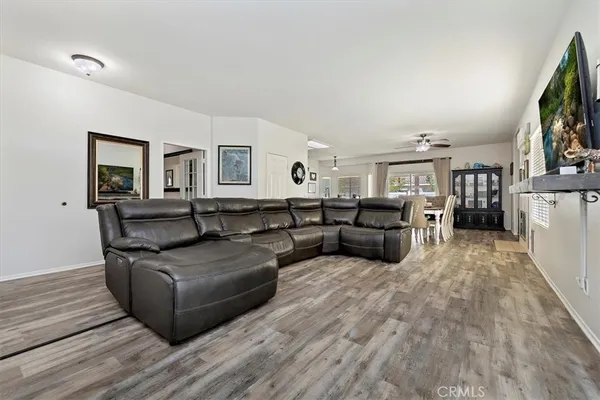 a living room with furniture flat screen tv and a fireplace