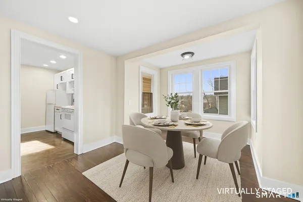a view of a dining room with furniture and wooden floor