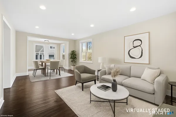 a living room with furniture and a wooden floor