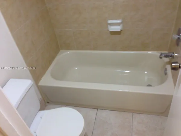a bathroom with a toilet and bathtub