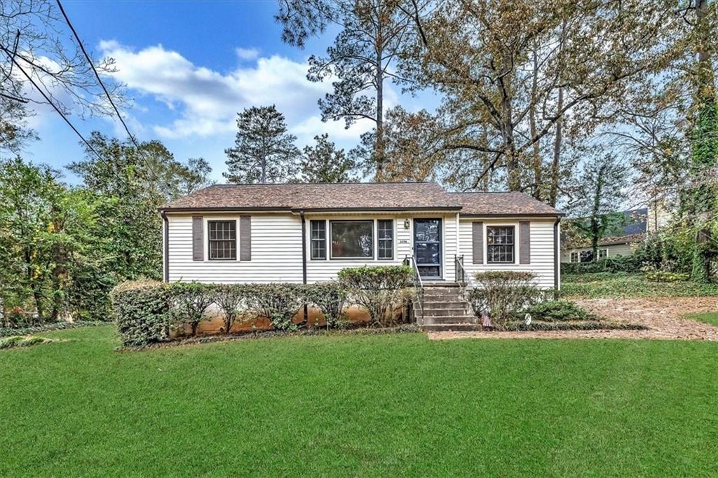 Single story home with a front yard