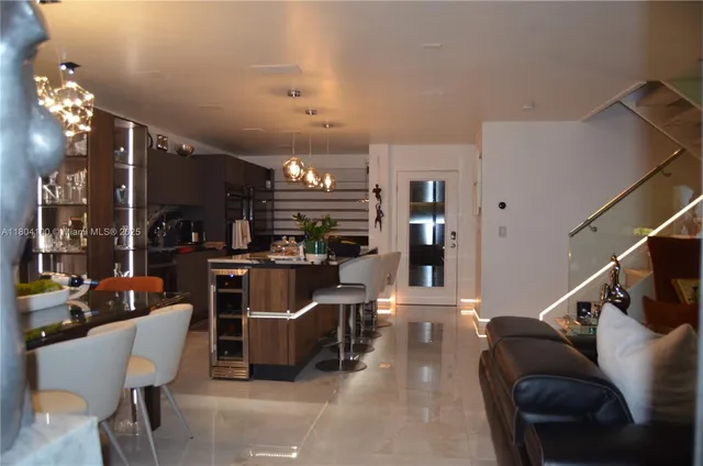 a living room with lots of furniture and a large window