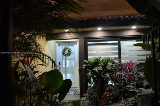 a living room with furniture a floor to ceiling window and a flat screen tv