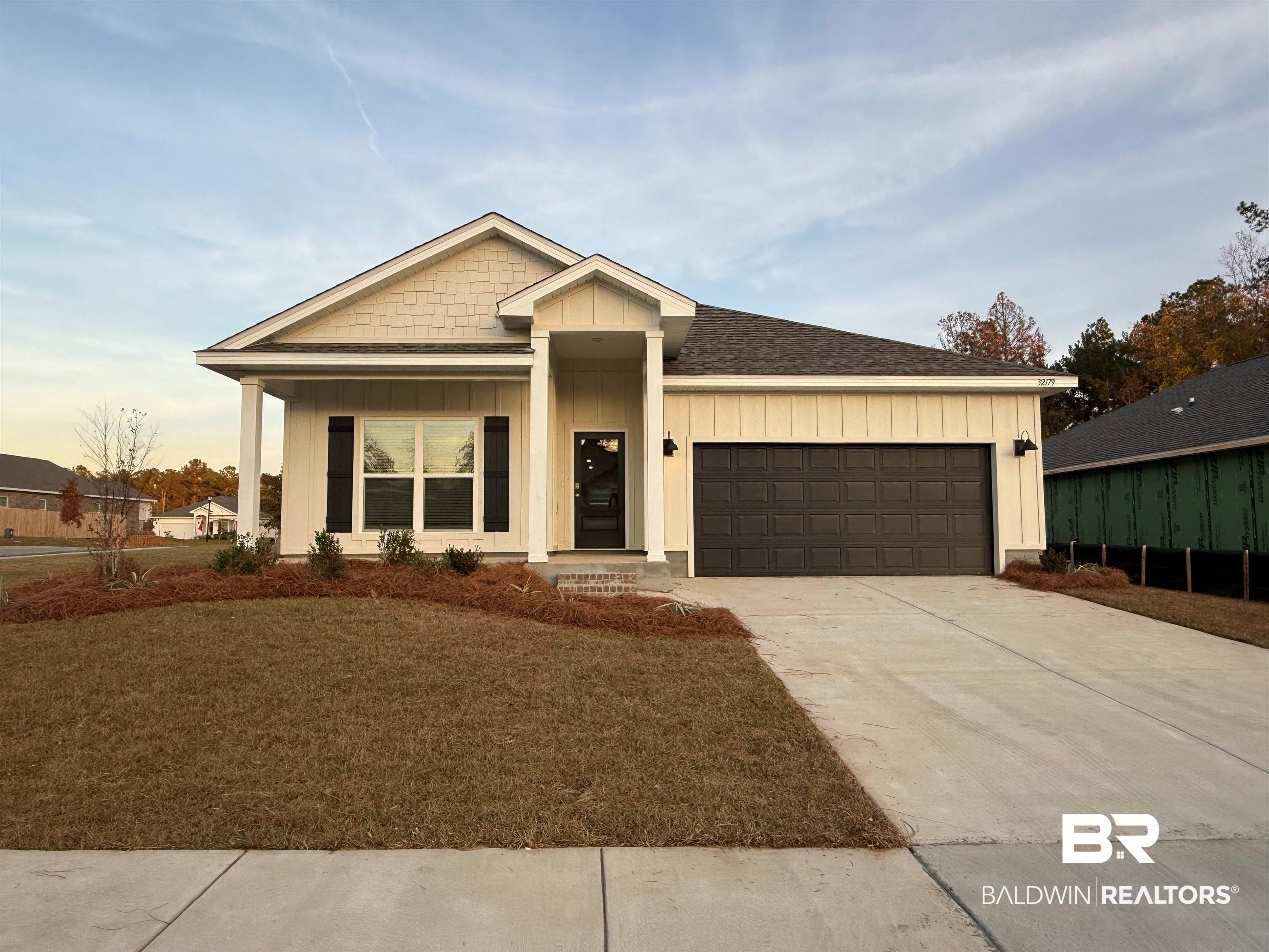 32179 Lyon Road Daphne, AL 36527 - Photo 1 of 34 View of front of home with board and batten siding, covered porch, driveway, a shingled roof, and an attached garage