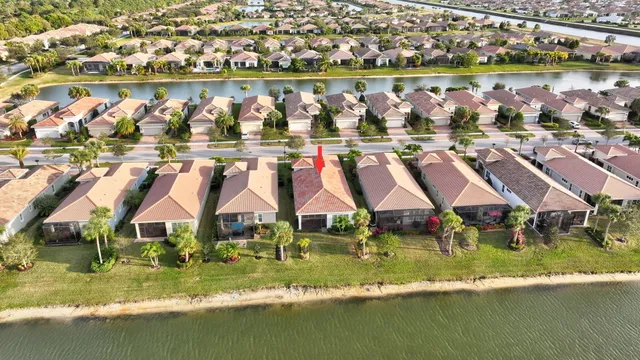 an aerial view of residential houses with outdoor space and swimming pool