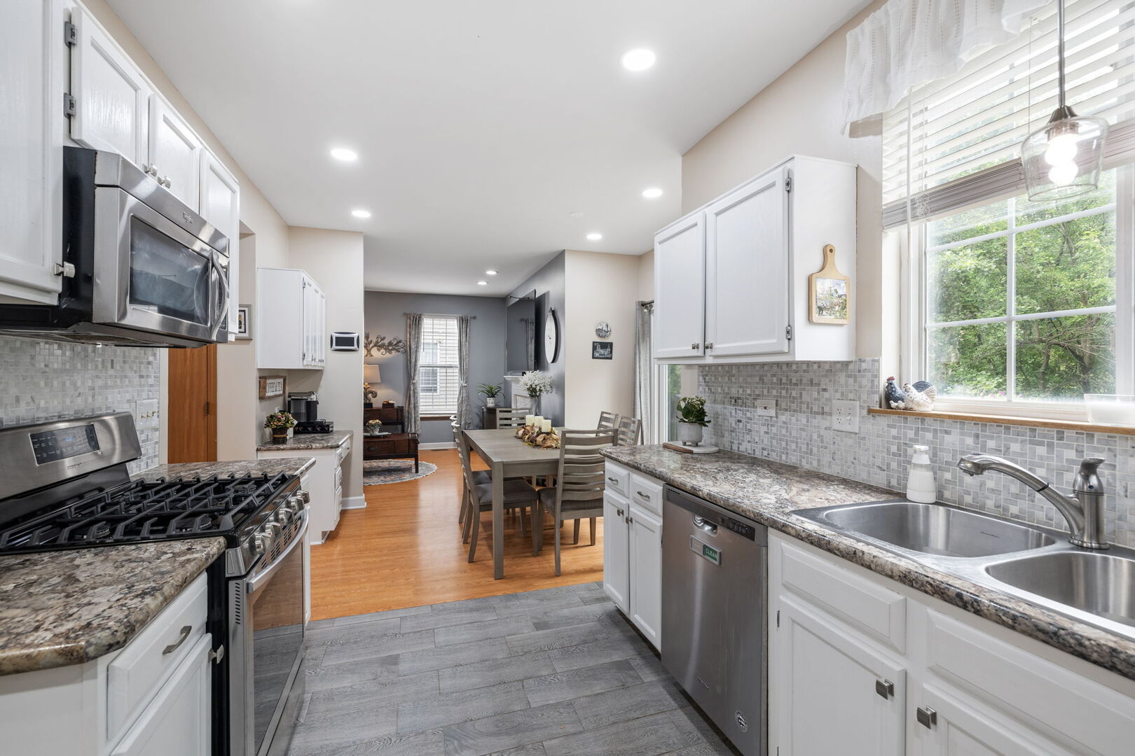 2161 Hammel Lane Aurora, IL 60504 - Photo 8 of 33 a kitchen with stainless steel appliances granite countertop wooden cabinets a sink a stove a refrigerator and a center island