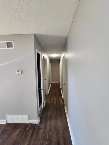 a view of hallway with wooden floor