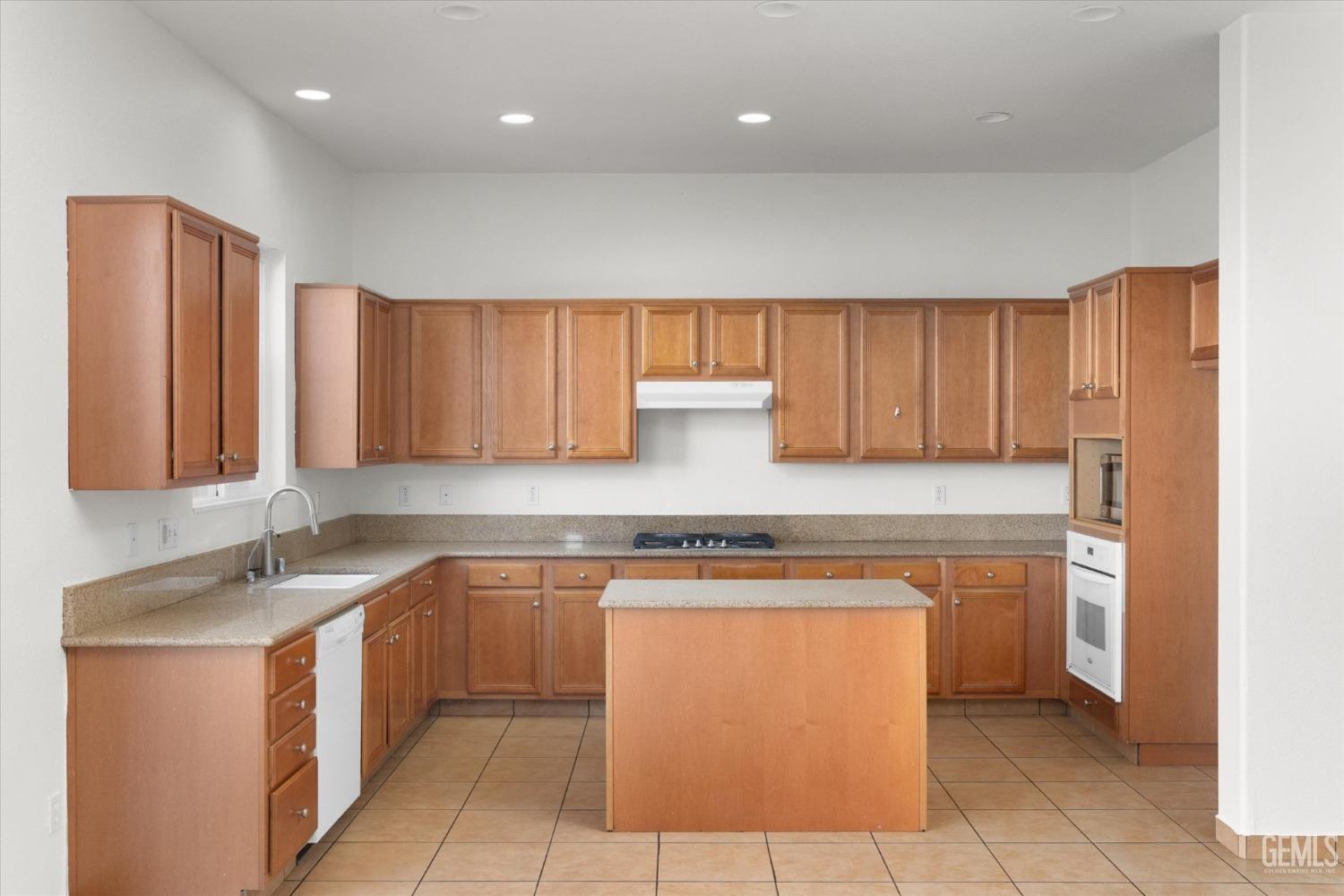 Undisclosed Address Bakersfield, CA 93313 - Photo 14 of 34 a kitchen with stainless steel appliances granite countertop a stove a sink and a microwave