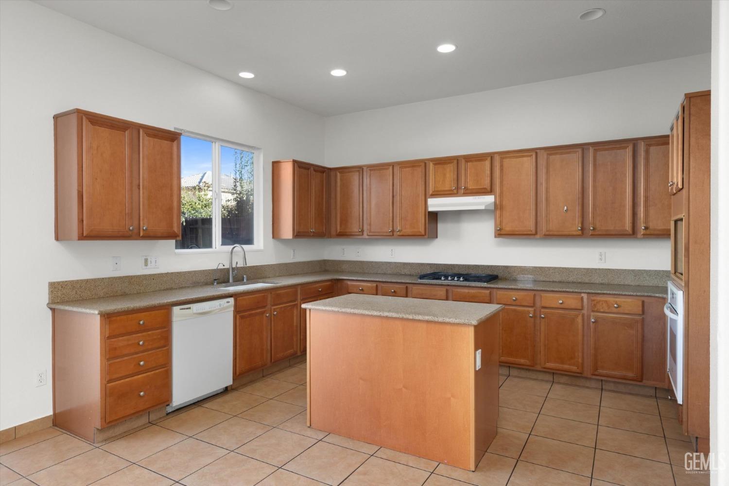 Undisclosed Address Bakersfield, CA 93313 - Photo 15 of 34 a kitchen with stainless steel appliances granite countertop wooden cabinets a sink and dishwasher