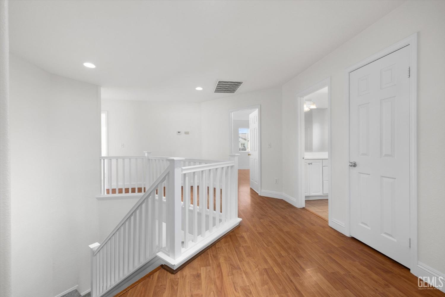 Undisclosed Address Bakersfield, CA 93313 - Photo 18 of 34 a view of a hallway with wooden floor
