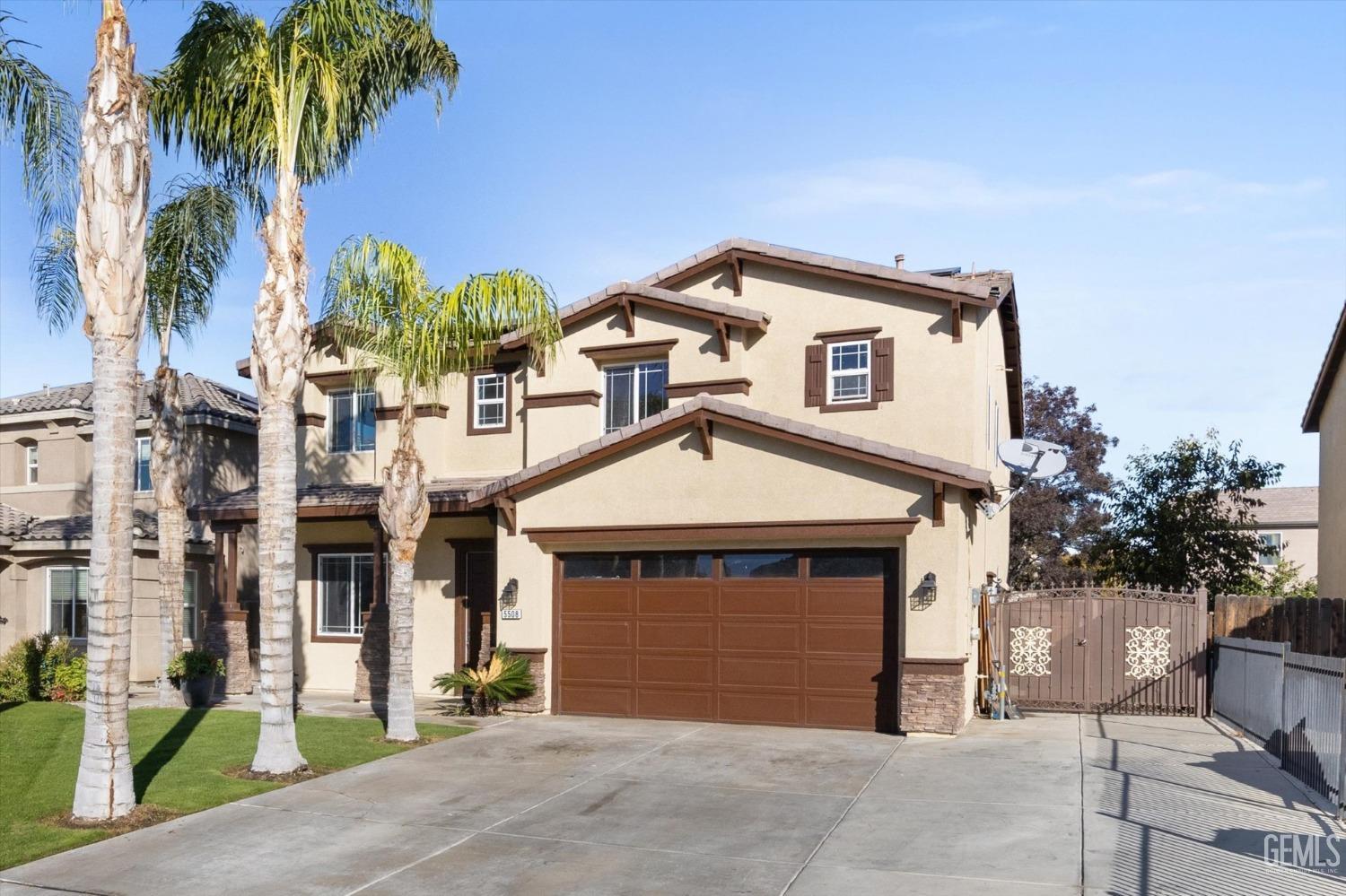Undisclosed Address Bakersfield, CA 93313 - Photo 2 of 34 a front view of a house with a yard and garage