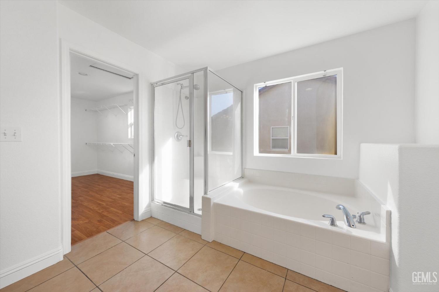 Undisclosed Address Bakersfield, CA 93313 - Photo 22 of 34 a bathroom with a bathtub and a shower